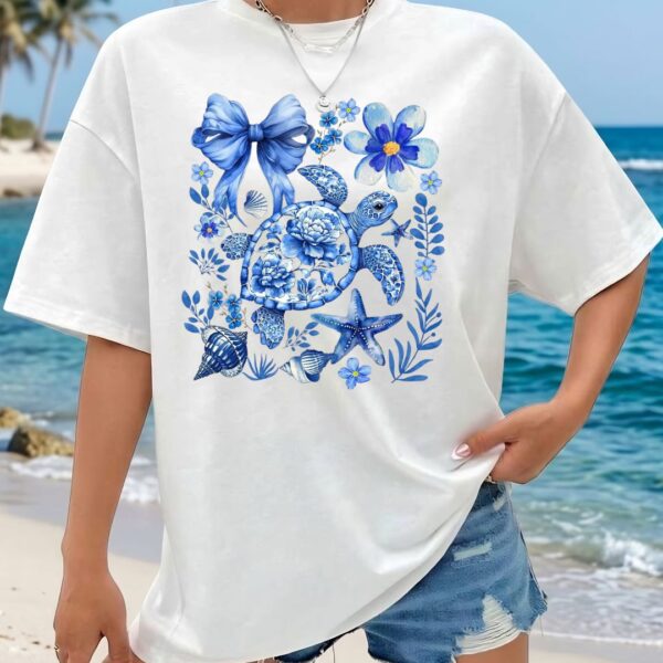 Women white oversized graphic t shirt with blue beach aesthetic print