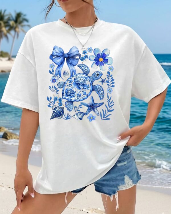 Women white oversized graphic t shirt with blue beach aesthetic print